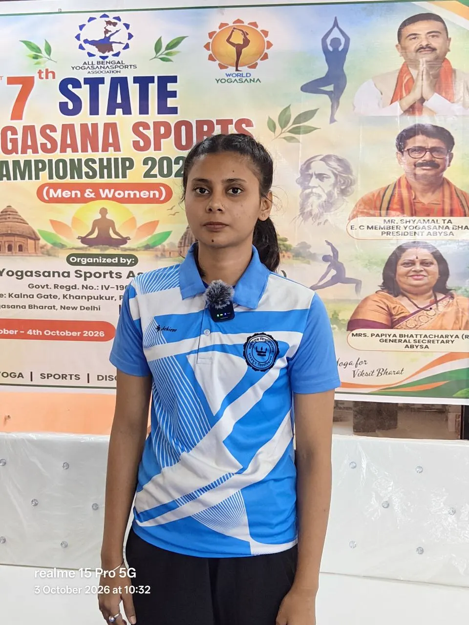 An athlete stands before the championship banner.